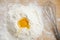 Flatlay of pile of flour and whisk on wooden table