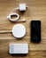 Flatlay of smartphone accessories on wooden table