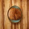 Flatlay traditional dark bread loaf on a plate with slices, on a wooden table