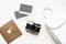 Flatlay vintage retro camera on wooden white background with empty instant paper photo placed your pictures. Top view