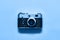 Flatlay vintage retro film camera on blue background. Copy space, top view. Minimalistic concept. Color of the year 2020 Classic