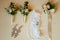 Flatlayout of wedding earrings, garter and boutonniere