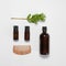 flatley with glass bottles of brown color and a wooden comb on a white isolated background. natural hair care
