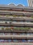 Flats built in post-war Brutalist style architecture at The Barbican in the City of London UK, with colourful flowers on the balco