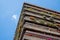 Flats built in post-war Brutalist style architecture at The Barbican in the City of London UK, with colourful flowers on the balco