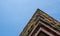 Flats built in post-war Brutalist style architecture at The Barbican in the City of London UK, with colourful flowers on the balco