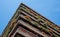 Flats built in post-war Brutalist style architecture at The Barbican in the City of London UK, with colourful flowers on the balco