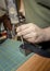 Flattening a Rivet into a Leather Strap