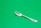 Flatware silver cake fork isolate on green background
