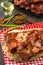 Flavored bbq spareribs with red peppers, green onion and olive o