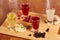 Flavored fruit liqueurs on wooden board. Citrus, berries, ginger