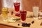 Flavored fruit liqueurs on wooden board. Citrus, berries, ginger