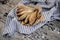 Flavored smoke-dried fish on plate on a baking paper on the grey striped napkin