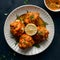 Flavorful chicken malai boti served with lemon on a dish