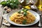 A Flavorful Presentation: Cooked Spaghetti Aglio e Olio with Garlic and Olive Oil, Glistening with Chili Flakes Sprinkled