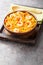 Flavorful Spanish yellow rice and shrimp with vegetables and spices closeup on the plate. Vertical