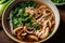 Flavorful Szechuan chicken noodle soup with bok choy, mushrooms, and scallions garnished with sesame seeds and cilantro