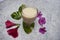 Flavoured Milk badam milk, A preparation of Milk with Almond and saffron, dried rose petals. Decorated with flowers and leaves.