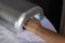 Flawless Finish: Woman\\\'s Nails Drying in UV Lamp at the Salon