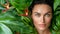 Flawless makeup on model in lush garden, exuding elegance and luxury in natural light