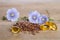 Flax seeds, beauty flowers and oil in caps on wooden background