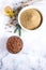 Flax seeds, flax flour, oil with sprouts and flax seed boxes on a light background