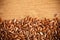 Flax seeds linseed border on wooden background