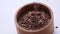 Flax seeds are poured into a wooden bowl, close-up