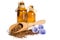 Flax seeds in the wooden scoop, bottles with oil and beauty flowers