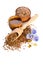 Flax seeds in the wooden scoop, bowl with oil and oil in caps and beauty flowers isolated on white background