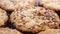 Flaxseeds and chia seeds fall onto oatmeal chocolate chip cookies. Macro.