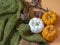 Flay lay autumn pumpkins with knitting sweater and dried leaves