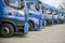 Fleet of commercial lorry trucks in row. Logistics and transportation service