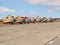 Fleet of damaged vintage Soviet civil passenger helicopters with no airscrews corroding outdoors on old abandoned airport`s landi