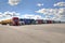 Fleet of lorries with trailer in courtyard of logistics terminal