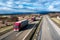 Fleet of Red Trucks - a convoy in line at a rural countryside highway