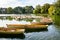 A fleet of rental rowboats bound to one another on a lake