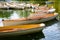 A fleet of rental rowboats bound to one another on a lake