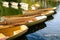 A fleet of rental rowboats bound to one another on a lake