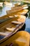 A fleet of rental rowboats bound to one another on a lake