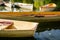 A fleet of rental rowboats bound to one another on a lake