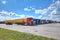 Fleet of semi trailer lorries in courtyard of logistics park.