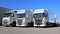 Fleet of White Scania and Volvo Trucks on a Yard