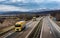 Fleet of Yellow Trucks - a convoy in line at a rural countryside highway