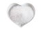 Fleur de sel in a heart-shaped bowl on white