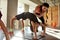 Flexibility in Every Move. Full-length shot of female trainer helping boy while kids are practising yoga by bending