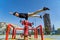 Flexible Acrobat keep balance with one hand on the fireman hydrant with blurred Dubai cityscape. Concept of modern and