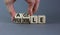 Flexible and agile symbol. Concept words Flexible and agile on wooden cubes. Businessman hand. Beautiful grey table grey
