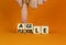 Flexible and agile symbol. Concept words Flexible and agile on wooden cubes. Businessman hand. Beautiful orange table orange