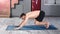 Flexible athletic Caucasian male practicing yoga exercise at home full shot